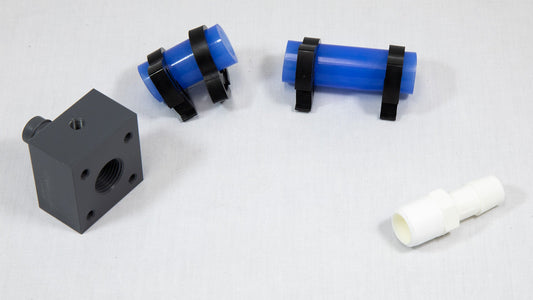 Sections of blue plastic tubing next to white and black connector components, showcasing their contrasting colors and materials.