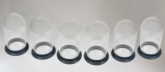 A collection of six clear vessels with sturdy bases.