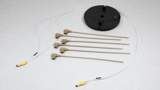 A collection various components alongside a black round object, highlighting their design and arrangement.