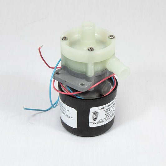 A small motor with multiple wires displayed on a white surface, showcasing its components and connections.