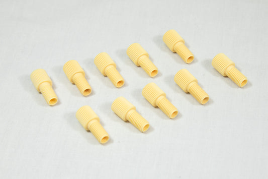 A collection of yellow plastic threaded fittings arranged on a clean white surface.