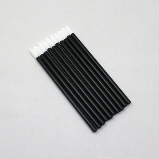 Black markers with white caps on a gray background