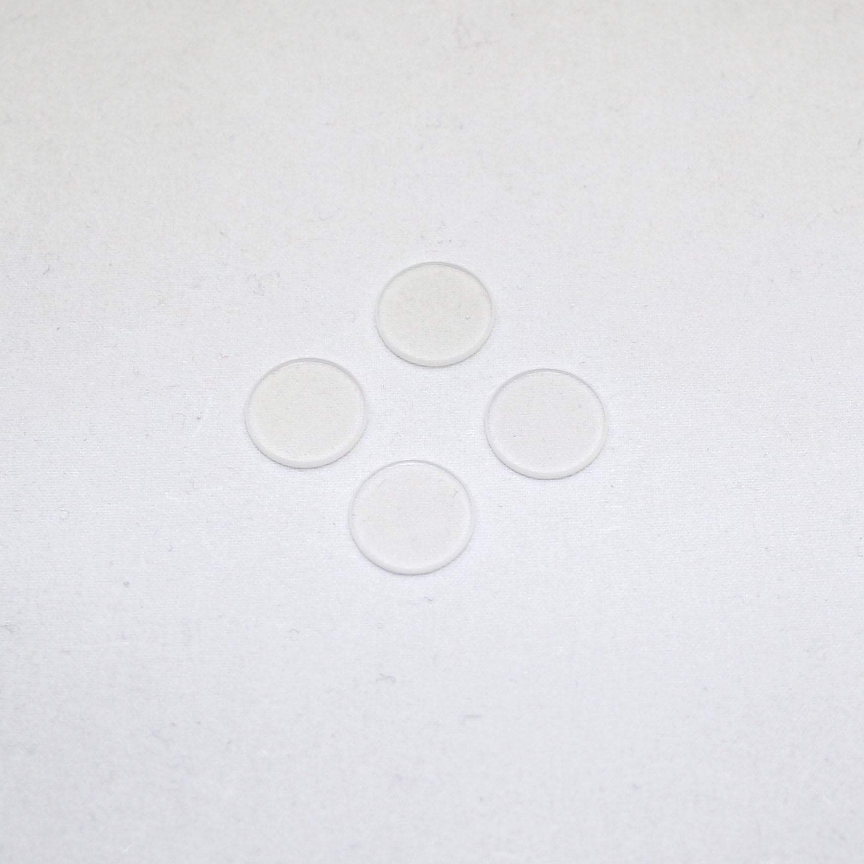 Four clear circular objects on a white background