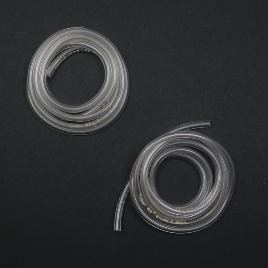Two coiled clear silicone hoses on a black background