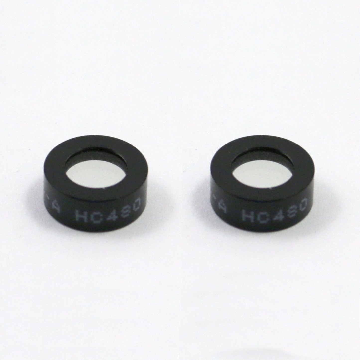 Two black circular objects with 'HC430' text on a white background