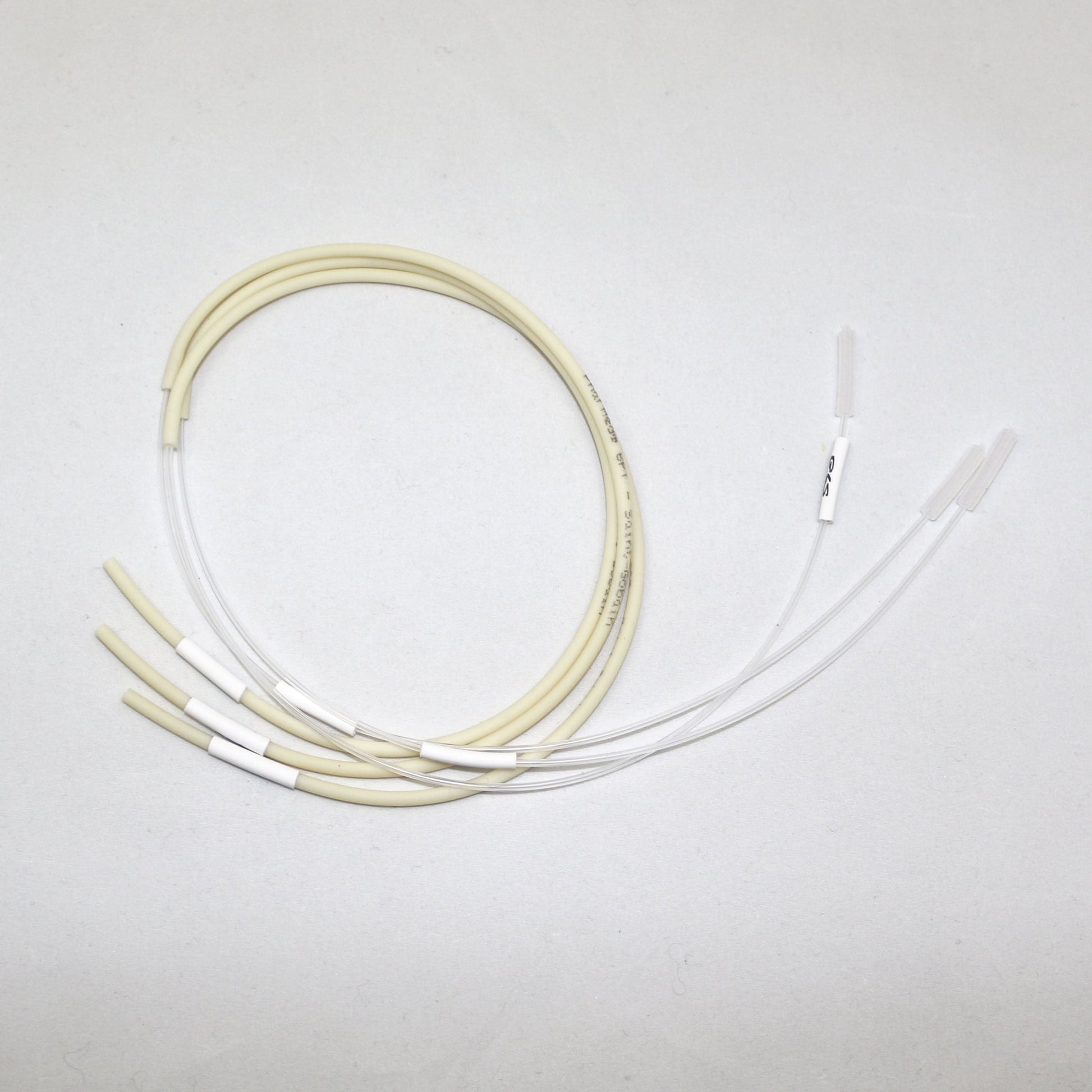 Set of white and beige tubes on a light gray background