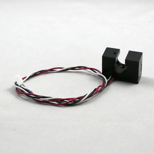 Black sensor with multicolored wires on a white background