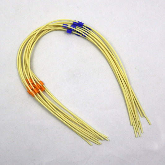 Pieces of yellow tubing with color-coded markers on a white background