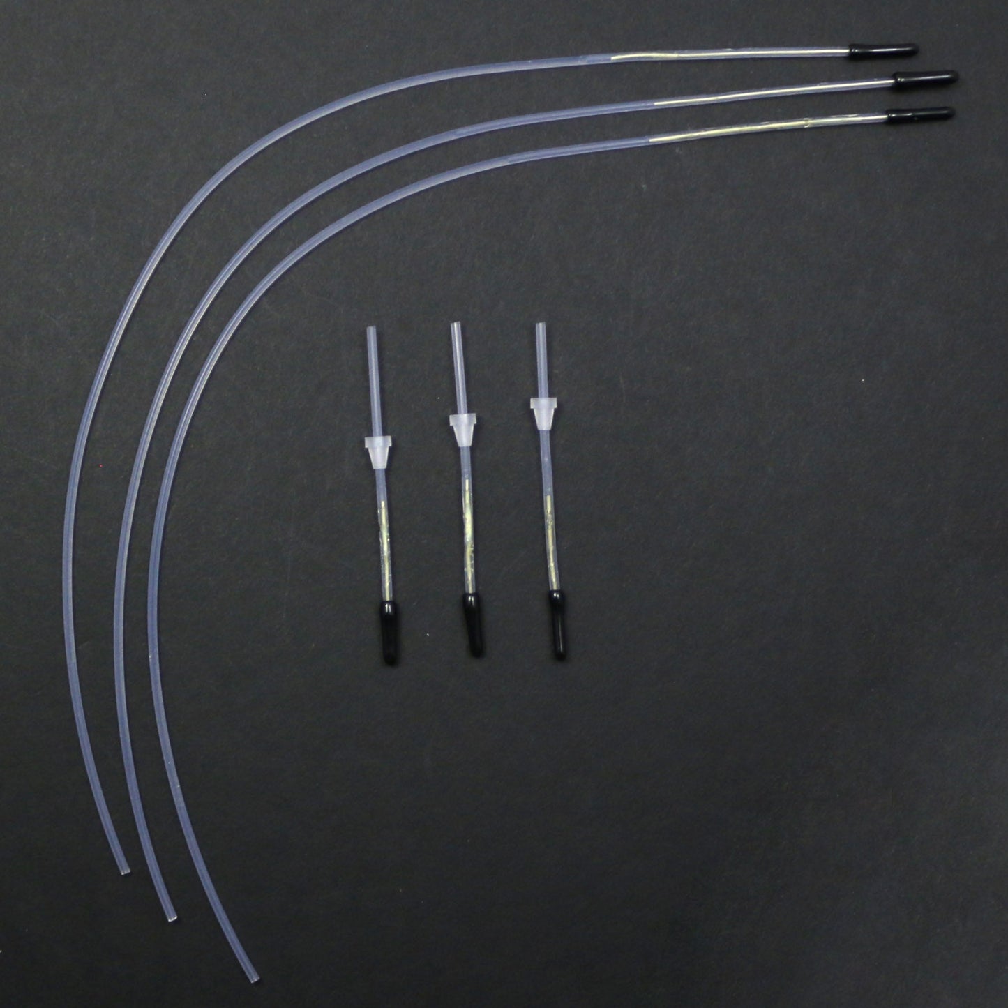Set of medical tubing and connectors on a dark background