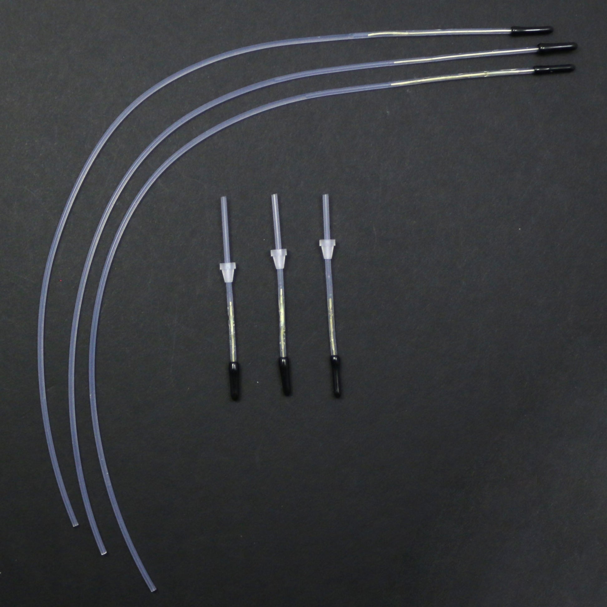 Set of medical tubing and connectors on a dark background