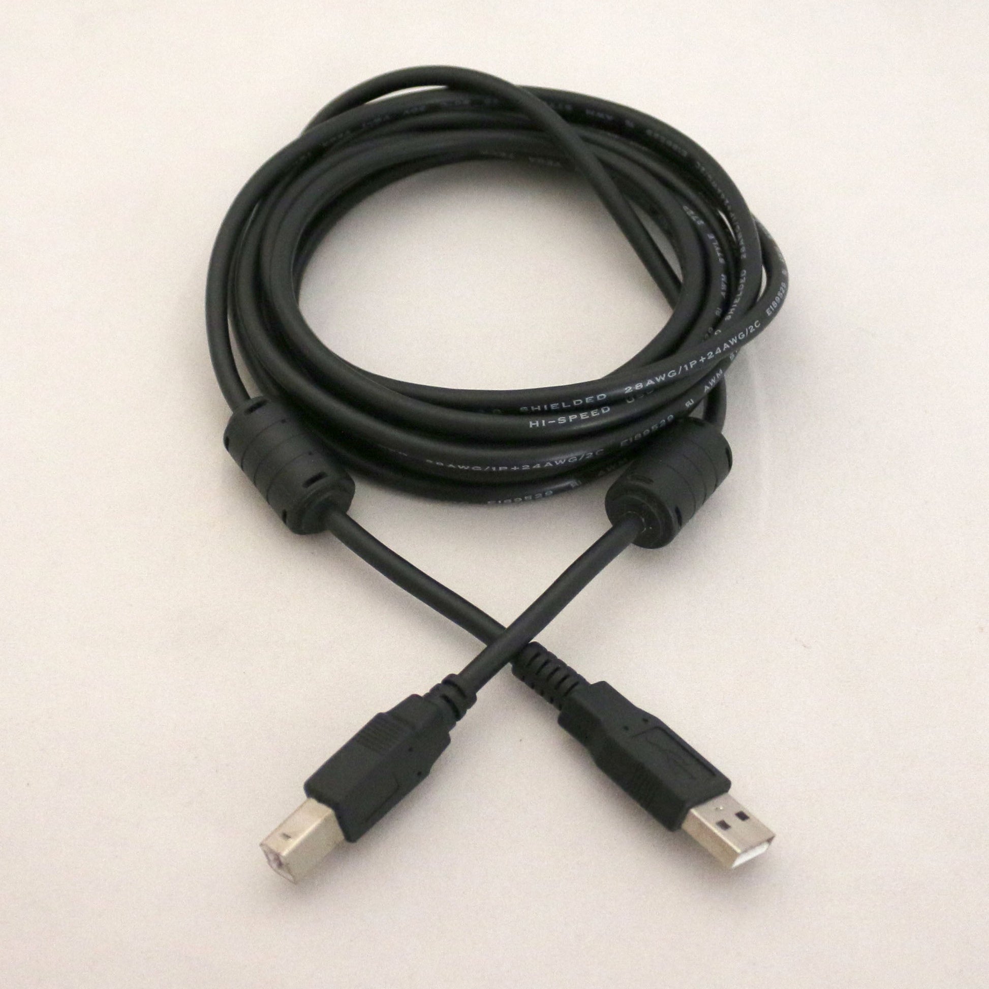 Black USB cable on a light beige background