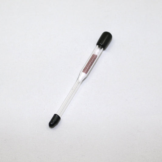 Glass hydrometer with black ends on a white background