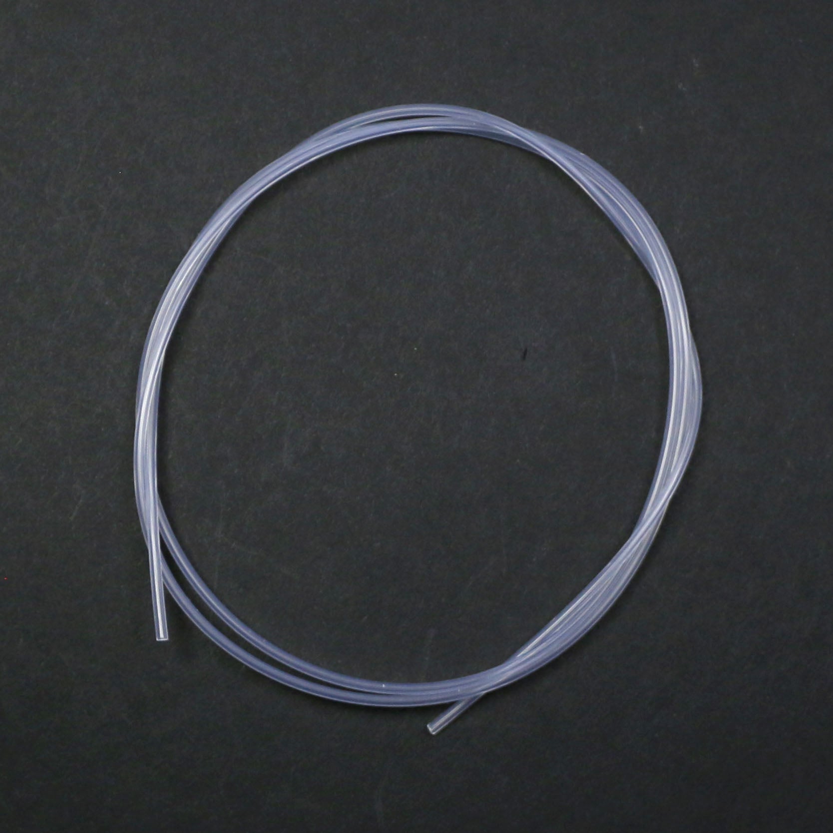 Clear silicone tube on a dark gray background