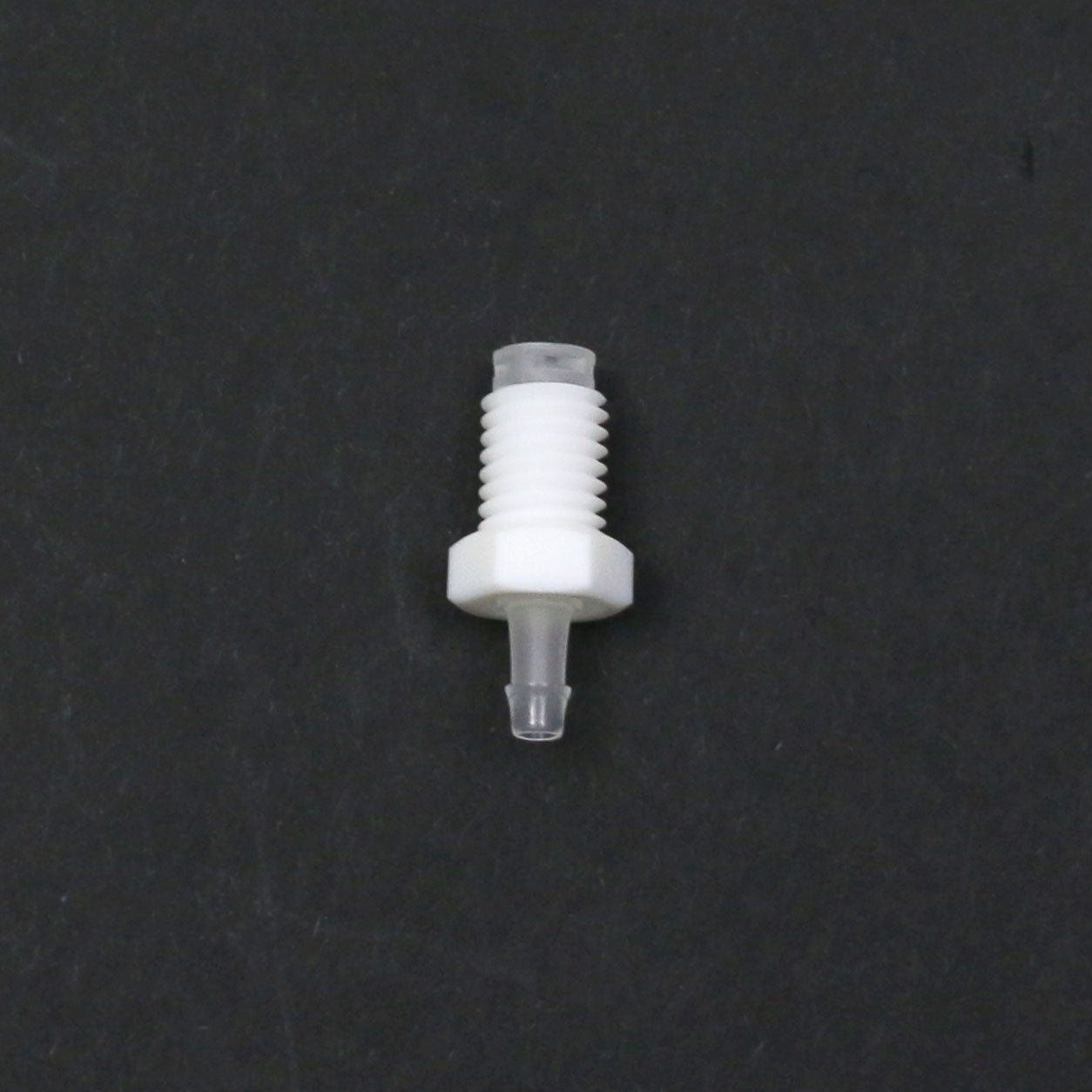 White plastic fitting on a black background