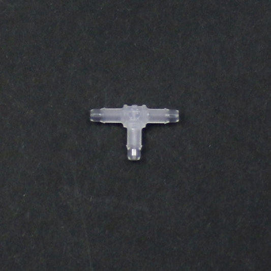 Clear plastic T-shaped connector on a black background