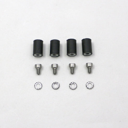 Set of black cylindrical parts and silver screws on a white background