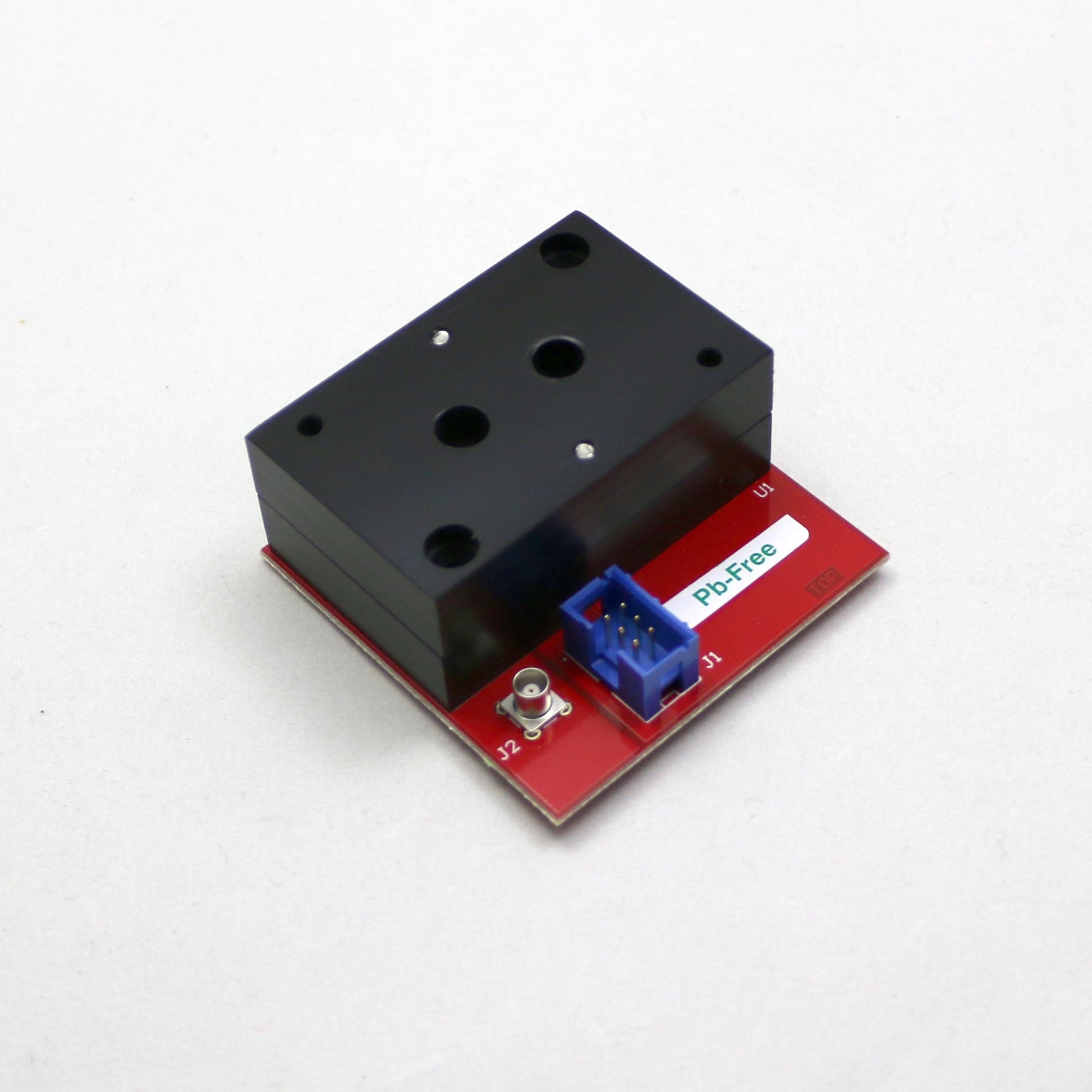 Electronic component with red and black casing on a white background