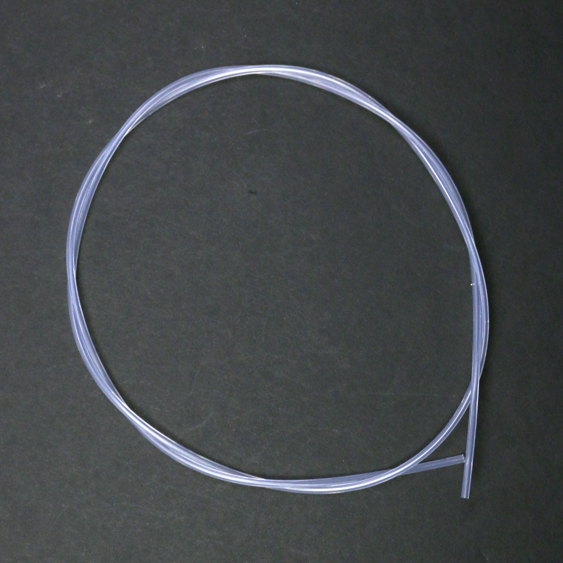 Coiled clear plastic tube on a dark gray background