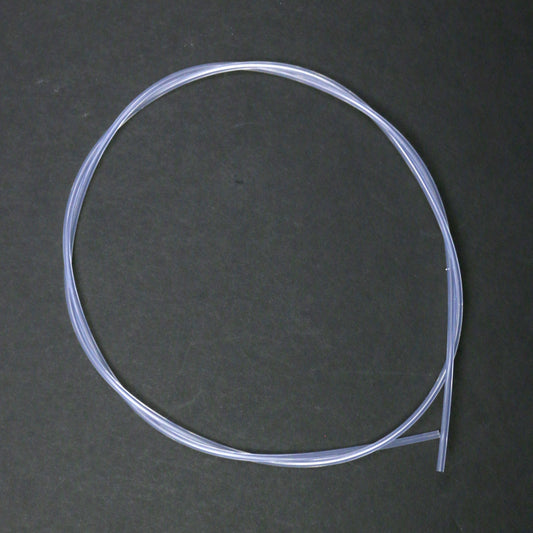 Coiled clear plastic tube on a dark gray background