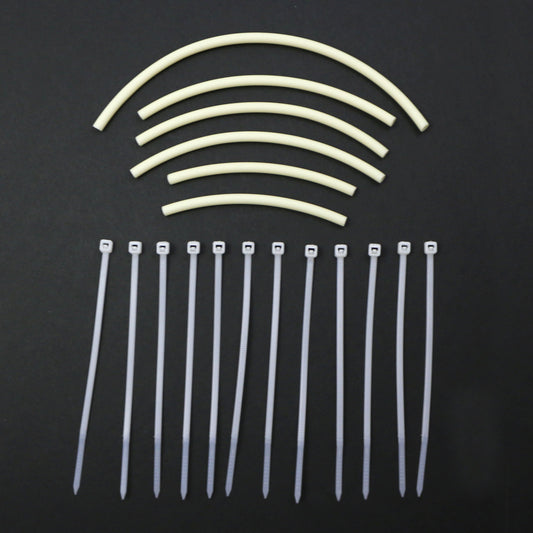 Set of cable ties and tubing pieces on a black background