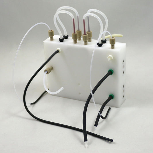 White plastic container with tubes and connectors on a gray background