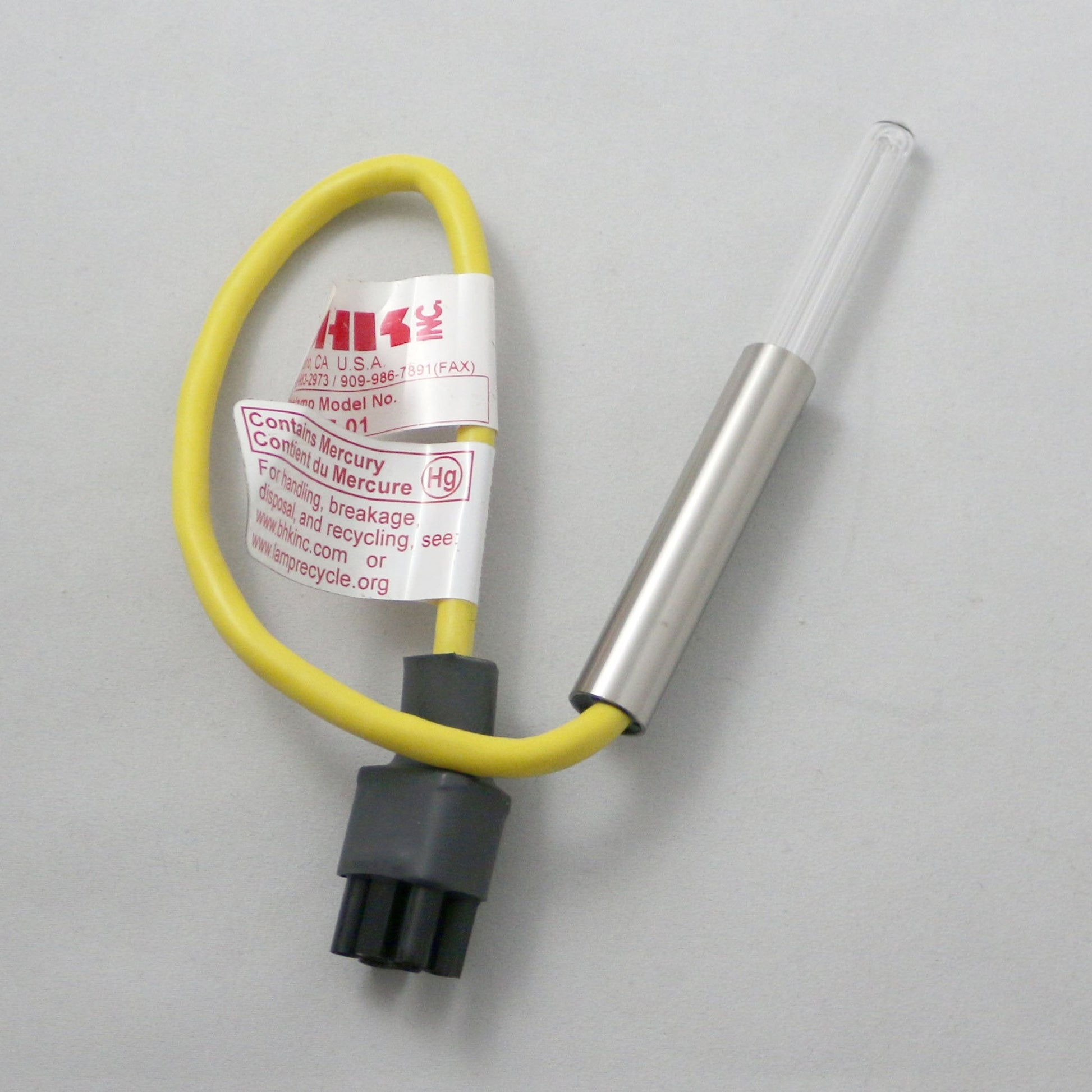Thermocouple with yellow cable and metal probe on a gray background
