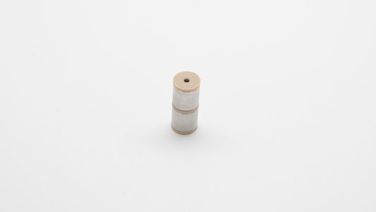 Cylinder with small hole in center.