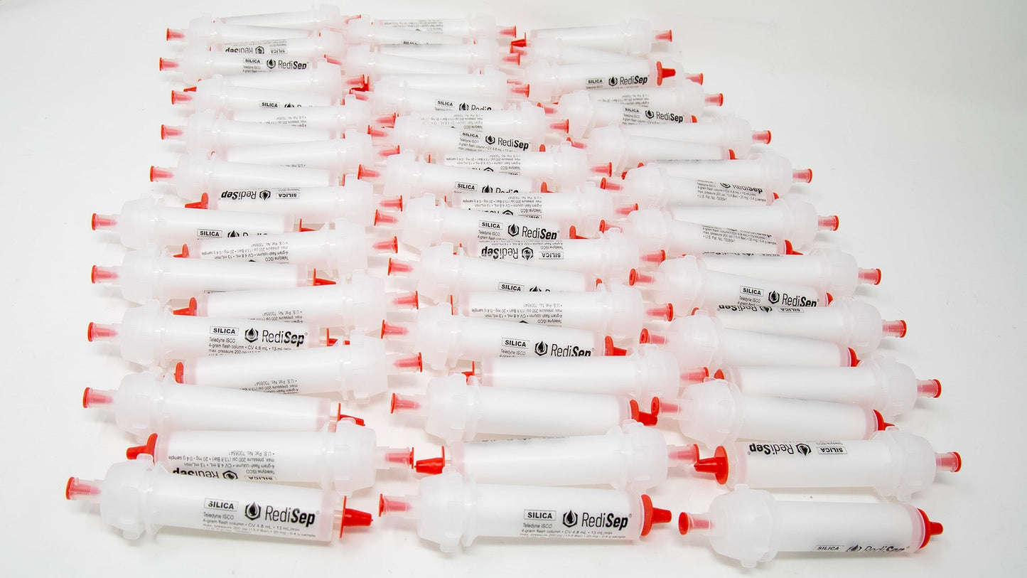 Several white tubes with black labels