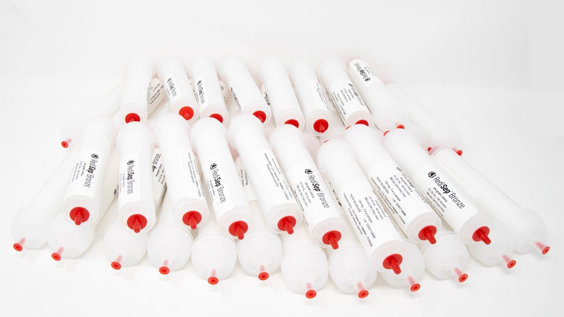 Several white tubes with black labels