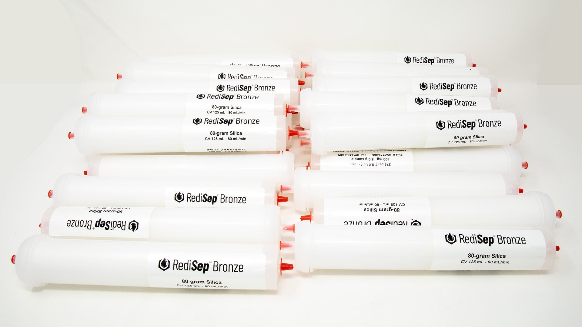 Several white tubes with black labels